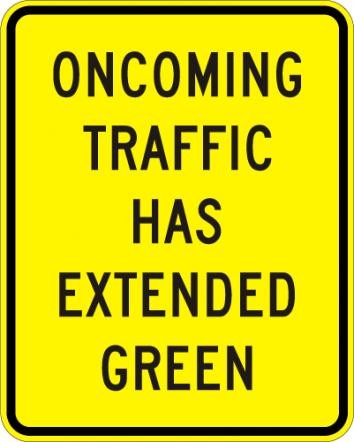 W25-1 Oncoming Traffic Has Extended Green Sign