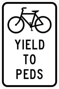 R9-6 - Bikes Yield to Peds Sign