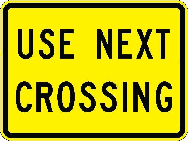 W10-14aP - Use Next Crossing Plaque Sign