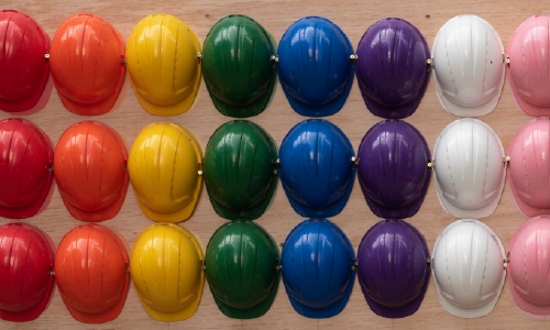 A selection of rainbow colored hard hats