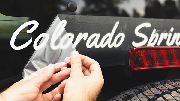 Custom Transfer Decal on a black truck. Text says Colorado Spring in cursive.