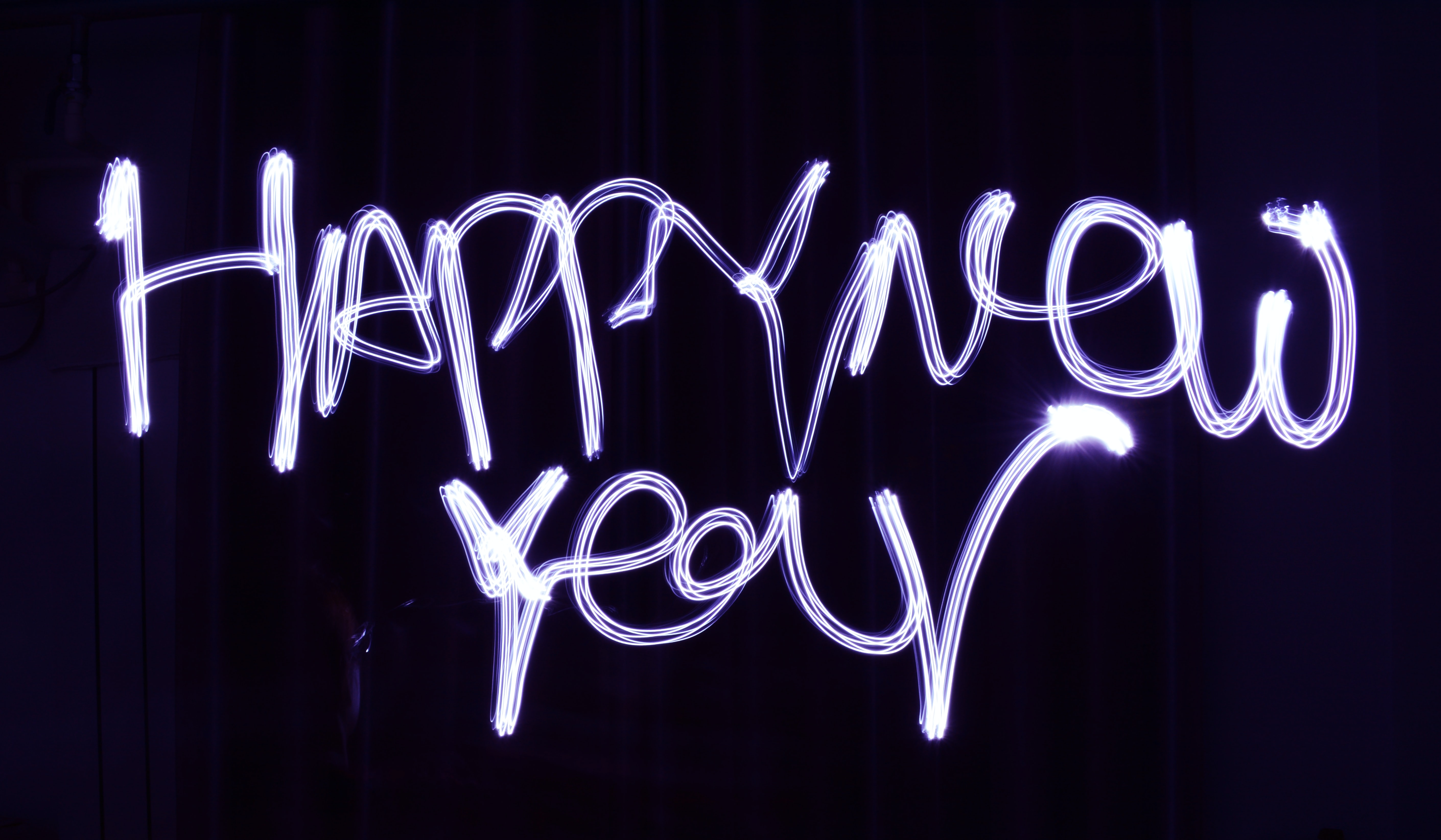 Purple glowing text that says Happy New Year