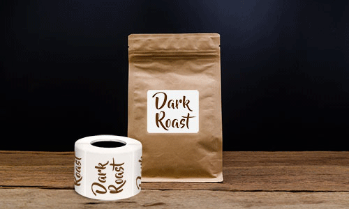 Square label on a brown bag of coffee beans that says Dark Roast.