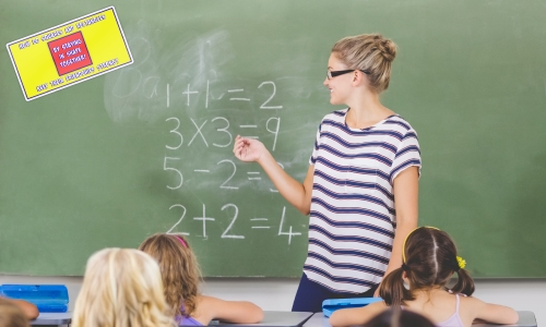 Teacher in white and blue striped t-shirt with short blonde hair and glasses. She is doing elementary math equations on a chalkboard with white chalk. There is a red and yellow rectangle decal on the chalk board.
