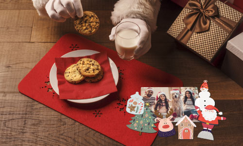 Plate of Christmas cookies with Christmas themed magnets on the side.