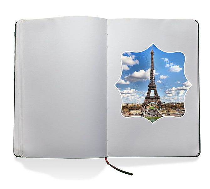 A photo sticker of the Eiffel Tower inside of a scrapbook.