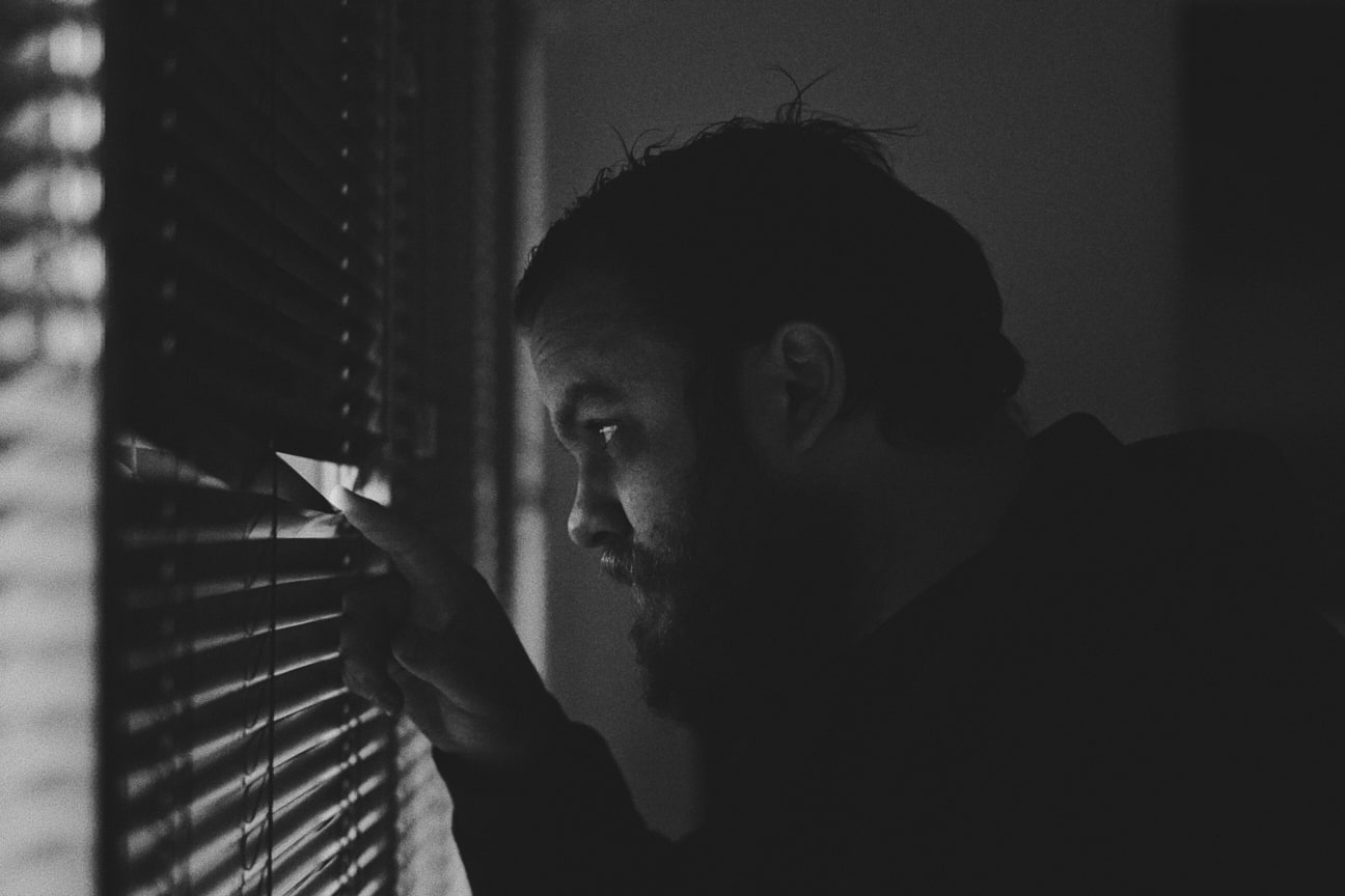 Man peeking out window