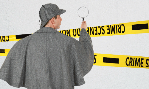 Sherlock Holmes look-a-like studying painted wall with a magnifying glass