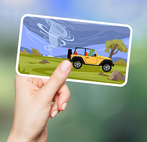 hand holding a rectangular sticker that has a tornado and a jeep on it