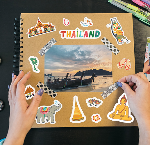 a scrapbook of a trip to Thailand that is covered in fun scrapbook stickers