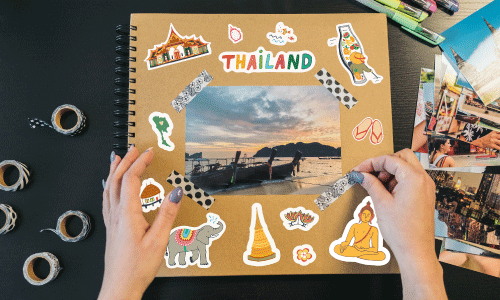 Scrapbook cover of Thai related items including an Elephant, Buddah and more.