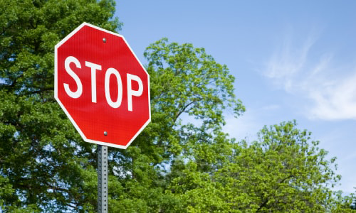 stop sign with trees in the background