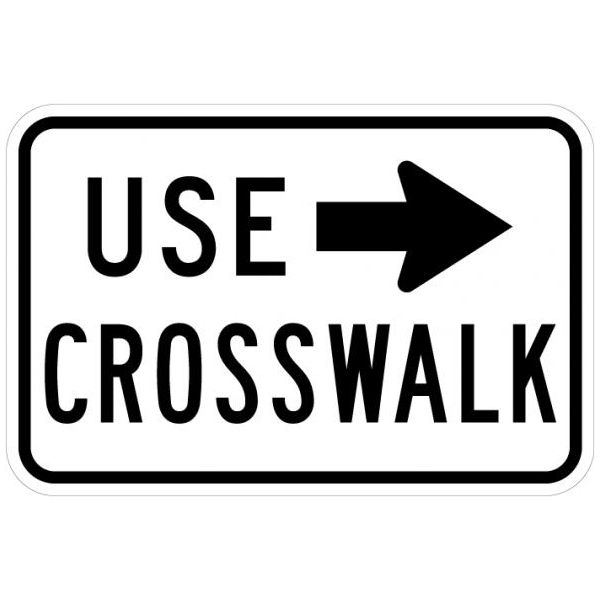 Black and white Use Crosswalk Sign with arrow pointing to the right.