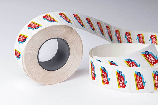 Slightly unrolled roll labels on a white background. Labels have a company logo on them.